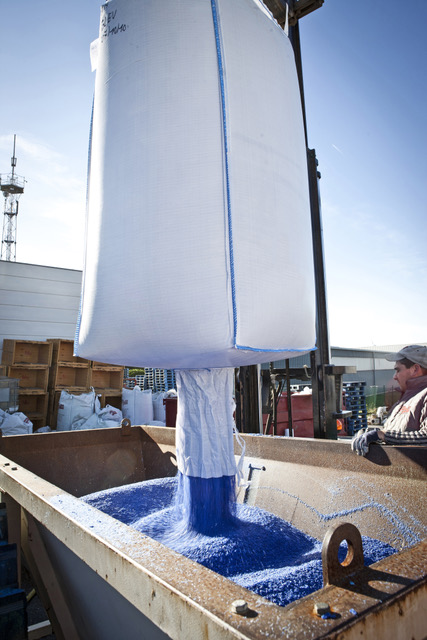 A big white bag that spills all the shredded blue paper into lots of pieces